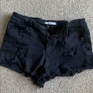 Black ripped jean shorts.